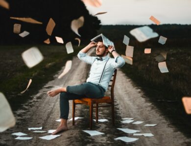 man sitting on chair with book