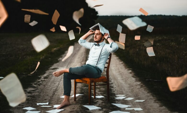 man sitting on chair with book