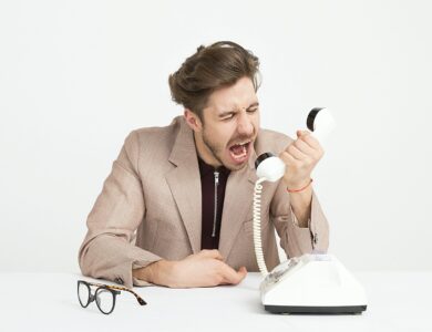 man holding telephone screaming