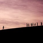 silhouette of people on hill