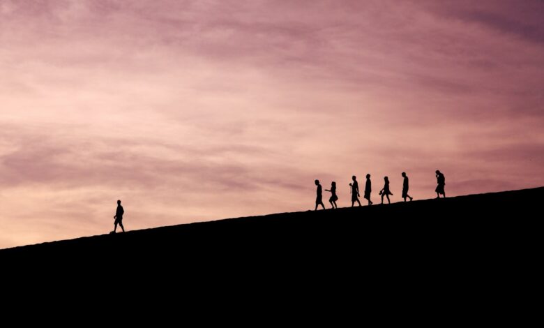 silhouette of people on hill