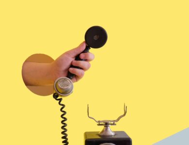 person holding black rotary telephone