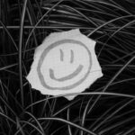 a piece of paper with a smiley face drawn on it