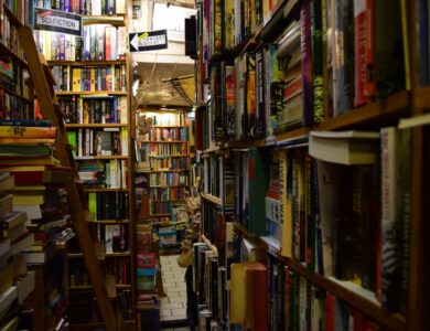 a narrow bookshelf filled with lots of books