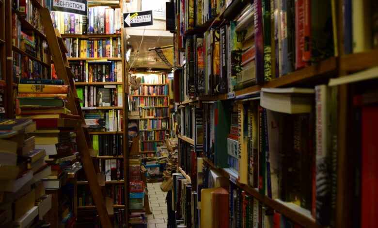 a narrow bookshelf filled with lots of books