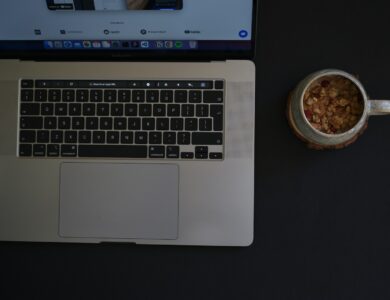 a laptop with a bowl of food