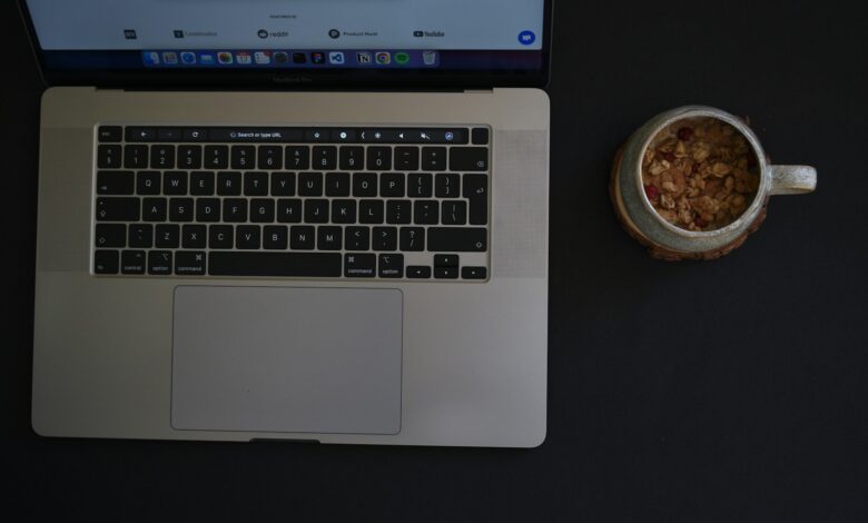 a laptop with a bowl of food