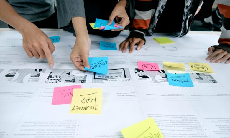 person in gray shirt holding white printer paper