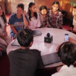 people sitting on floor front of table