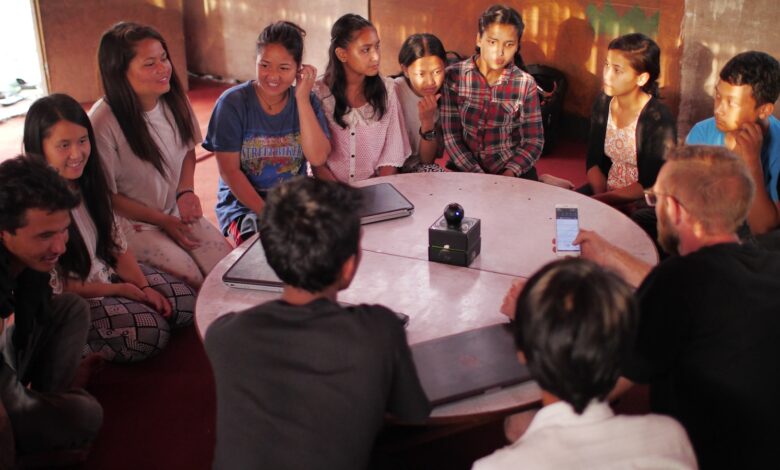 people sitting on floor front of table