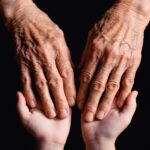 Old hands cradling the younger ones.