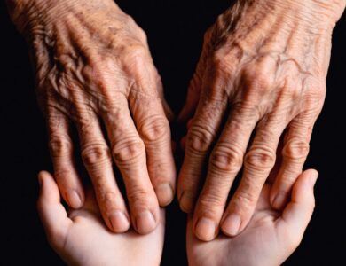 Old hands cradling the younger ones.