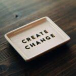 A white tray with the words create change written on it