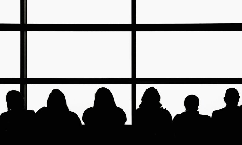 silhouette of people sitting on chair