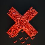 a cross made out of small pieces of red plastic