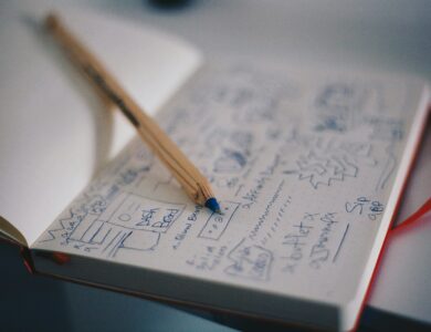 blue ballpoint pen on white notebook