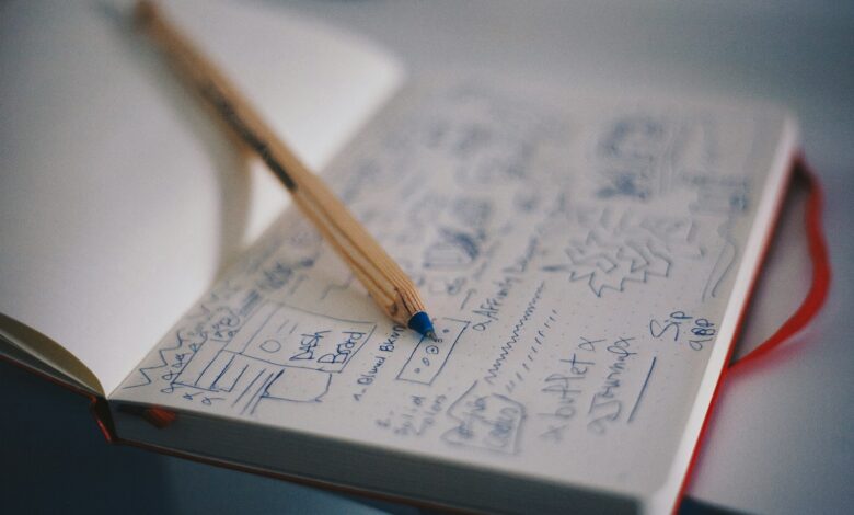 blue ballpoint pen on white notebook